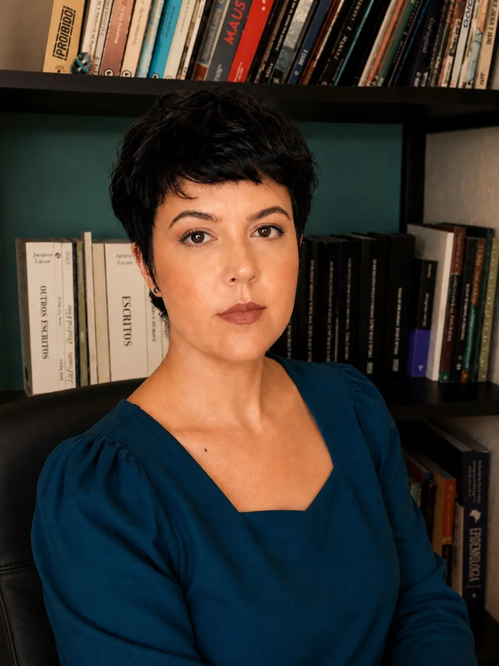 Luciana Marinho, psicóloga, diante de uma estante com livros de psicanálise